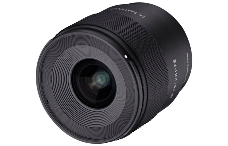 A close-up view of a black camera lens with detailed grooves around the front glass element and the brand "Samyang" visible on the side.