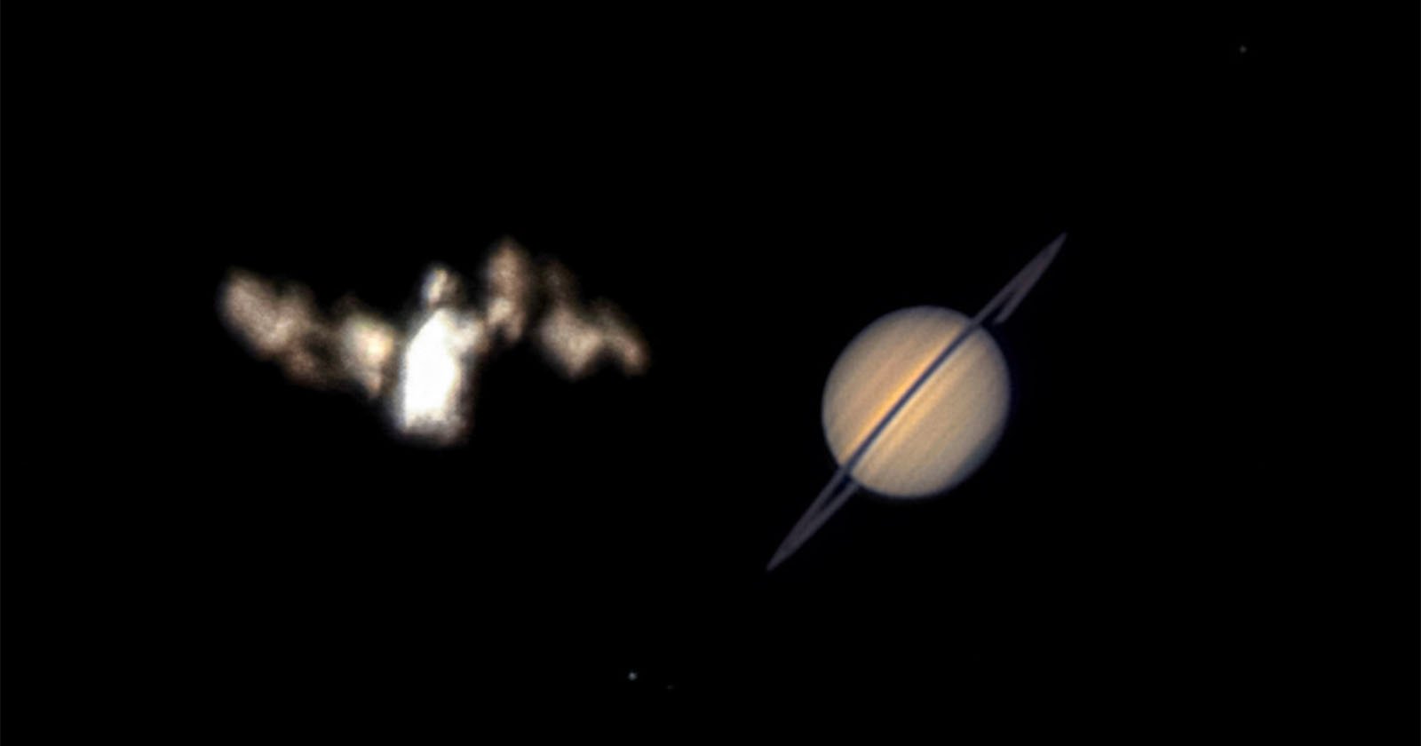 A blurry, bright object resembling the Bat-Signal appears on the left, while the planet Saturn with visible rings is clearly seen on the right, both set against a black background.