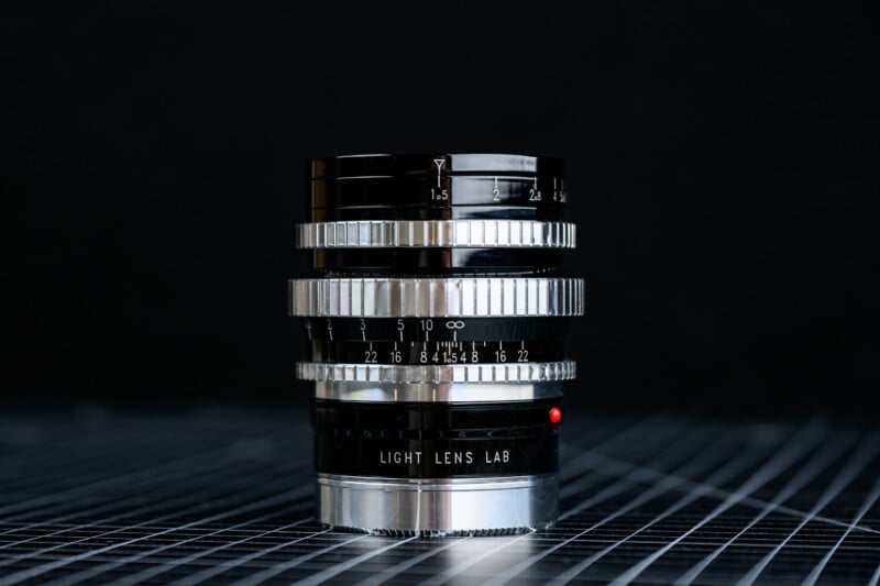 A close-up of a shiny, black and silver camera lens labeled 