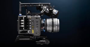 A professional ARRI ALEXA 35 cinema camera mounted in a black metal rig with various controls and a large lens, set against a dark gradient background.