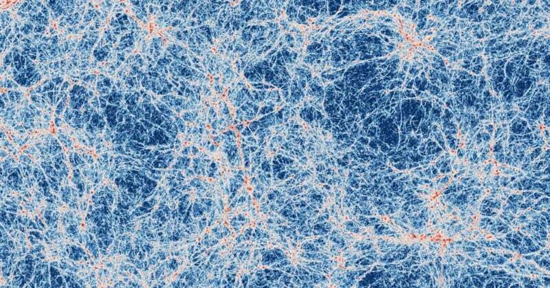 A complex web of interconnected blue and red filaments resembling a cosmic or neural network pattern, with dense clusters and branching lines creating an intricate, abstract design.