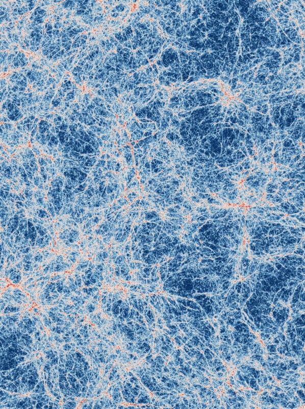 A complex web of interconnected, thin, light blue and orange lines on a dark blue background, resembling a network or cosmic web structure.