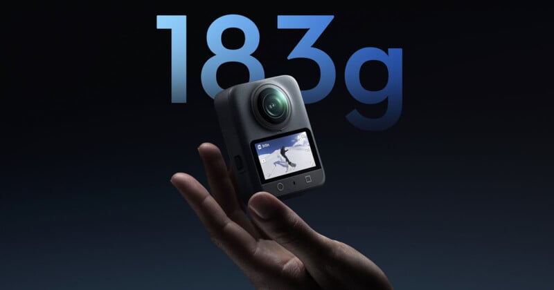 A hand holds a compact action camera with a display showing a skiing scene. Large text in the background reads “183g,” indicating the camera’s weight. The background is dark and minimalist.