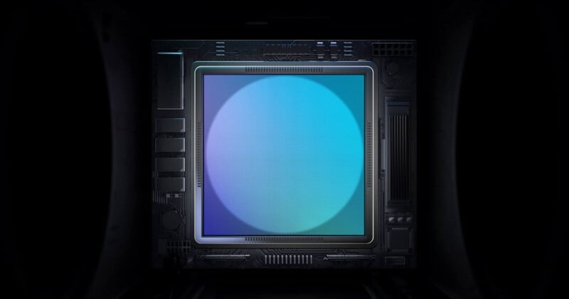 A glowing microchip with a large, blue gradient circle at its center, surrounded by dark circuitry and electronic components in a dimly lit environment.