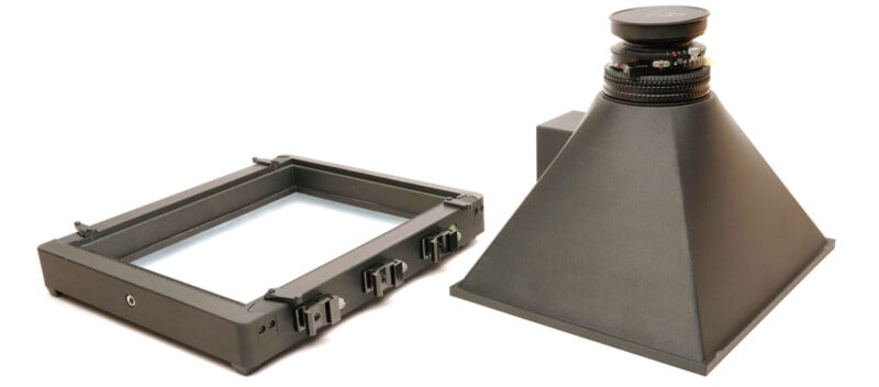 Two pieces of photographic equipment: a rectangular lightbox with control switches on the left, and a conical magnifying viewer with a lens on top on the right, both in black color.