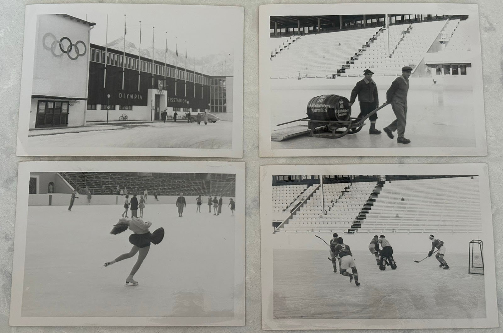 Four black-and-white photos of a winter sports stadium: the outside of the Olympic building, workers moving equipment, a figure skater mid-spin, and a group playing ice hockey on the rink.
