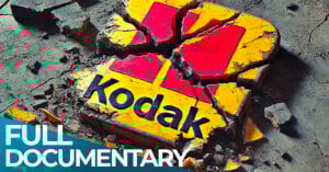 A broken Kodak logo lies on a cracked concrete surface, symbolizing decline. Bold text in the corner reads "FULL DOCUMENTARY.