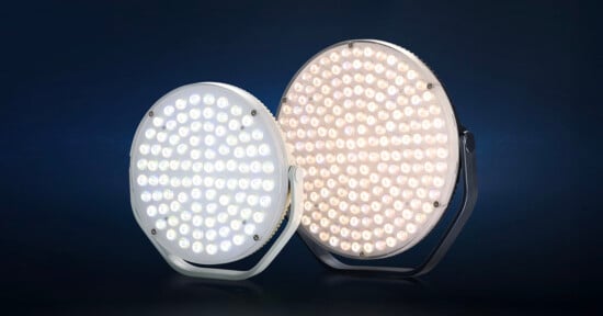 Two round LED stage lights are shown side by side against a dark background. One emits a cool white light, while the other emits a warm white light. Both lights have multiple small LED bulbs arranged in a circular pattern.