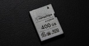 A close-up of a 400 GB Novachips Express memory card with 800 MB/s speed, resting on a textured black surface.
