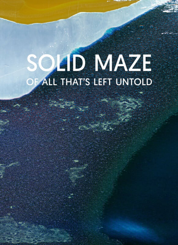 Abstract image with dark blue, white, and gold textured areas; overlaid text reads "SOLID MAZE" in large font and "OF ALL THAT'S LEFT UNTOLD" below in smaller font.