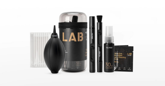 A camera cleaning kit with a black air blower, cleaning brushes, a spray bottle, lens wipes, cotton swabs, and a container, all labeled with “LAB” and “Viltrox” on a white background.