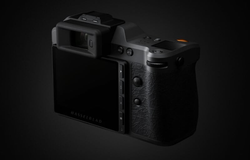 A black Hasselblad digital camera is shown from the back and side, displaying its large screen, textured grip, and various buttons, all set against a dark background.