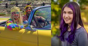 Two men in colorful 1970s-style clothes and wigs sit in a yellow convertible car, smiling. Next to them, a girl with long purple hair and a gray shirt smiles at the camera outdoors.