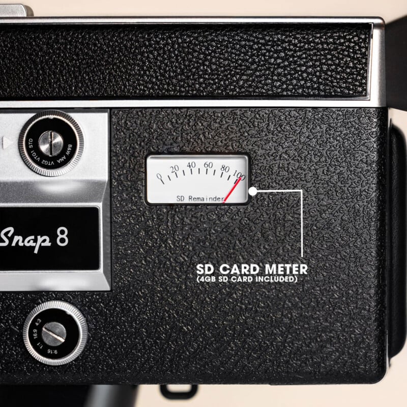 Close-up of a vintage camera labeled "Snap 8" with a meter labeled "SD Card Meter" showing SD card storage. Text notes a 4GB SD card is included. The camera has a textured black surface and silver dials.