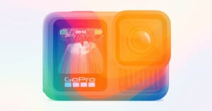 A GoPro action camera with a vibrant, translucent rainbow gradient overlay, showing its front display screen with a landscape image and the GoPro logo beneath.