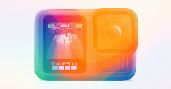 A GoPro action camera with a vibrant, translucent rainbow gradient overlay, showing its front display screen with a landscape image and the GoPro logo beneath.