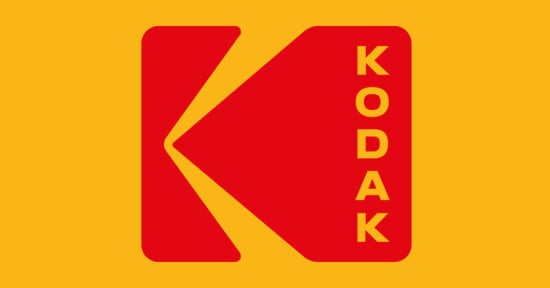 Red Kodak logo with a stylized "K" on a yellow background; the word “KODAK” appears vertically in yellow letters on the right side of the logo.