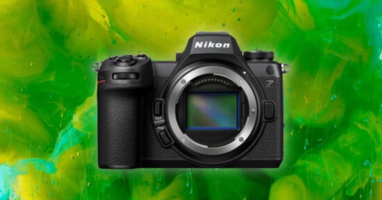 A Nikon Z series mirrorless camera is centered against a vibrant green and yellow abstract background.