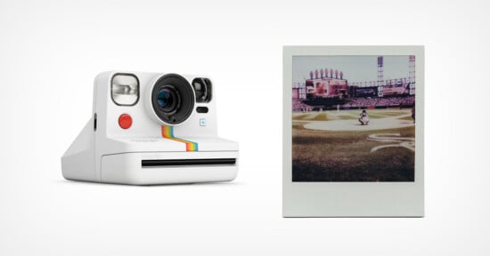 A white instant camera with rainbow stripes is shown next to a developed instant photo of a baseball game on a stadium field. The camera and photo are on a plain white background.