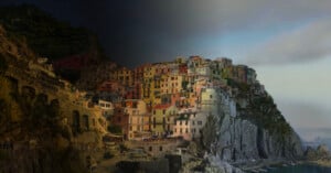 A coastal village with colorful buildings on a rocky cliff is shown in both daylight and nighttime by a diagonal split, highlighting the contrast between bright and dark lighting on the landscape and structures.