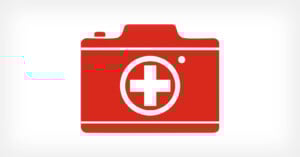 A red camera icon with a white medical cross in the center, symbolizing medical photography or healthcare imaging, on a white background.
