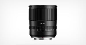 A black camera lens with “AF 75/2” printed on it, featuring a focus ring and an aperture ring with marked f-stops, shown against a plain white background.