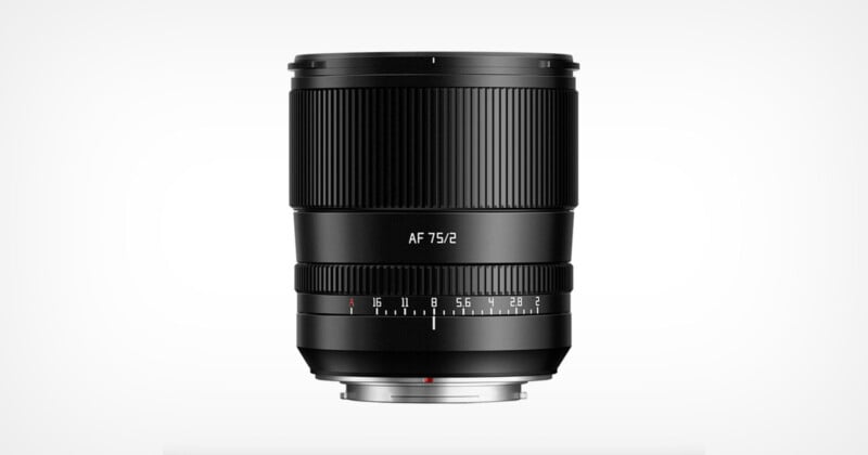 A black camera lens with “AF 75/2” printed on it, featuring a focus ring and an aperture ring with marked f-stops, shown against a plain white background.