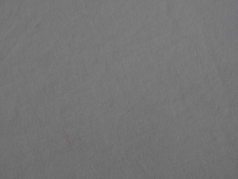 Close-up of a light gray fabric with a subtle diagonal weave pattern, showing a smooth, uniform texture without any visible seams or embellishments.