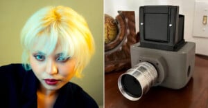 On the left, a person with short platinum blonde hair and red lipstick looks slightly down. On the right, there is a vintage-style boxy camera with a metallic lens resting on a wooden surface.