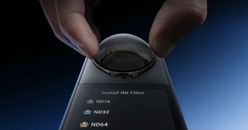 A close-up of two fingers holding a rounded camera lens, with a digital device screen below displaying options to install ND16, ND32, and ND64 ND filters. The background is a gradient of dark blue.