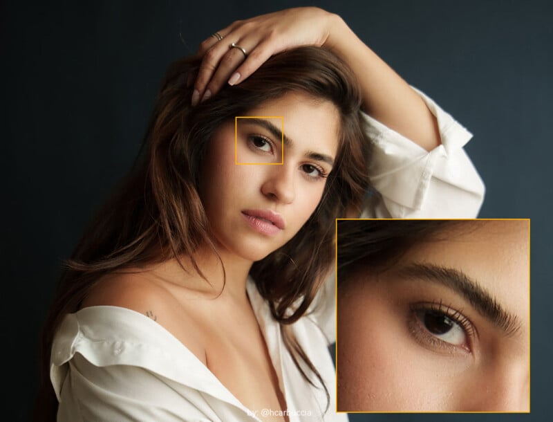 A woman with long brown hair and a white off-shoulder top poses with her hand on her head. A yellow box highlights her left eye, and an enlarged inset shows a close-up of that eye and eyebrow.