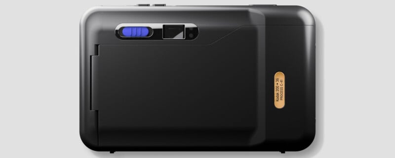 A black Kodak Ektar H35 film camera is shown from the back on a light gray background, featuring a blue slider, small viewfinder, and a gold label with product details.