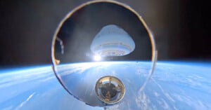 A spacecraft capsule separates from its rocket stage above Earth, with the planet’s blue horizon and the blackness of space in the background.