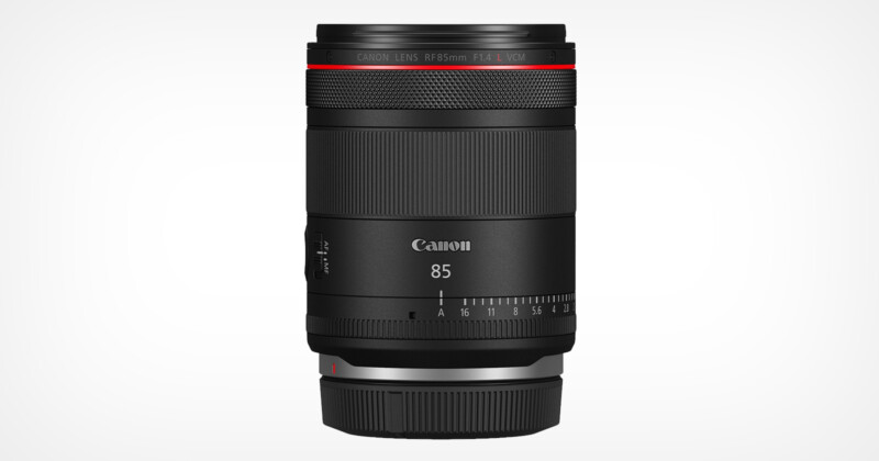 A Canon RF 85mm F1.4 L lens in black, standing vertically against a plain white background. The lens features a red ring near the top and clearly marked focus and aperture settings.