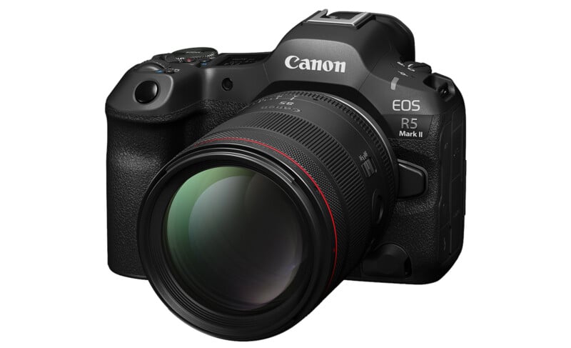 A black Canon EOS R5 Mark II digital camera with a large lens attached, shown from a front angle on a white background.