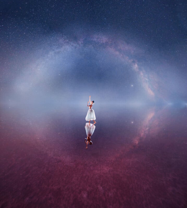 A woman in a white dress stands on a reflective surface under a starry sky, reaching upward. The sky forms a glowing arc, creating a circular effect mirrored below her. The colors are dreamy purples and blues.