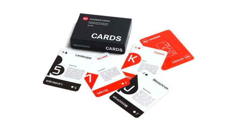 A set of playing cards with a black box labeled "CARDS." The cards are spread out, featuring minimalist designs with categories like Landscape, Street, Classic, and Monochrome in black, white, and red colors.