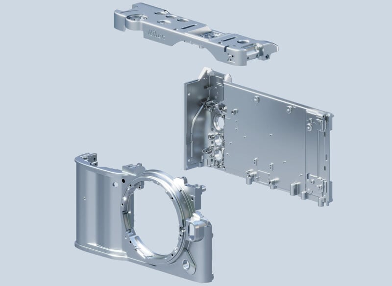 A 3D-rendered image showing three separate metallic components of a camera body, including the front, back, and top plates, all displayed against a light blue background in an exploded view.