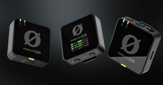 Three black Rode Wireless Pro microphone units are shown floating against a dark background, with LED indicators and labels visible on each device. The central unit displays a digital screen with signal and battery icons.