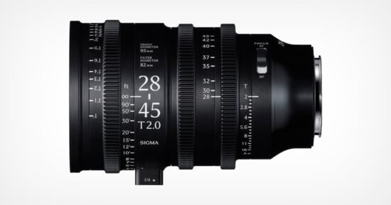 A black Sigma 28-45mm T2.0 cine lens with white engraved markings for focus, zoom, and aperture, shown against a plain white background, viewed from the side.