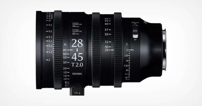 A black Sigma 28-45mm T2.0 cine lens with white engraved markings for focus, zoom, and aperture, shown against a plain white background, viewed from the side.