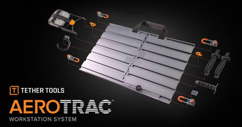 A metallic workstation system with grooves is surrounded by various orange and black mounting accessories. The logo reads "Tether Tools AeroTrac Workstation System" on a dark background.