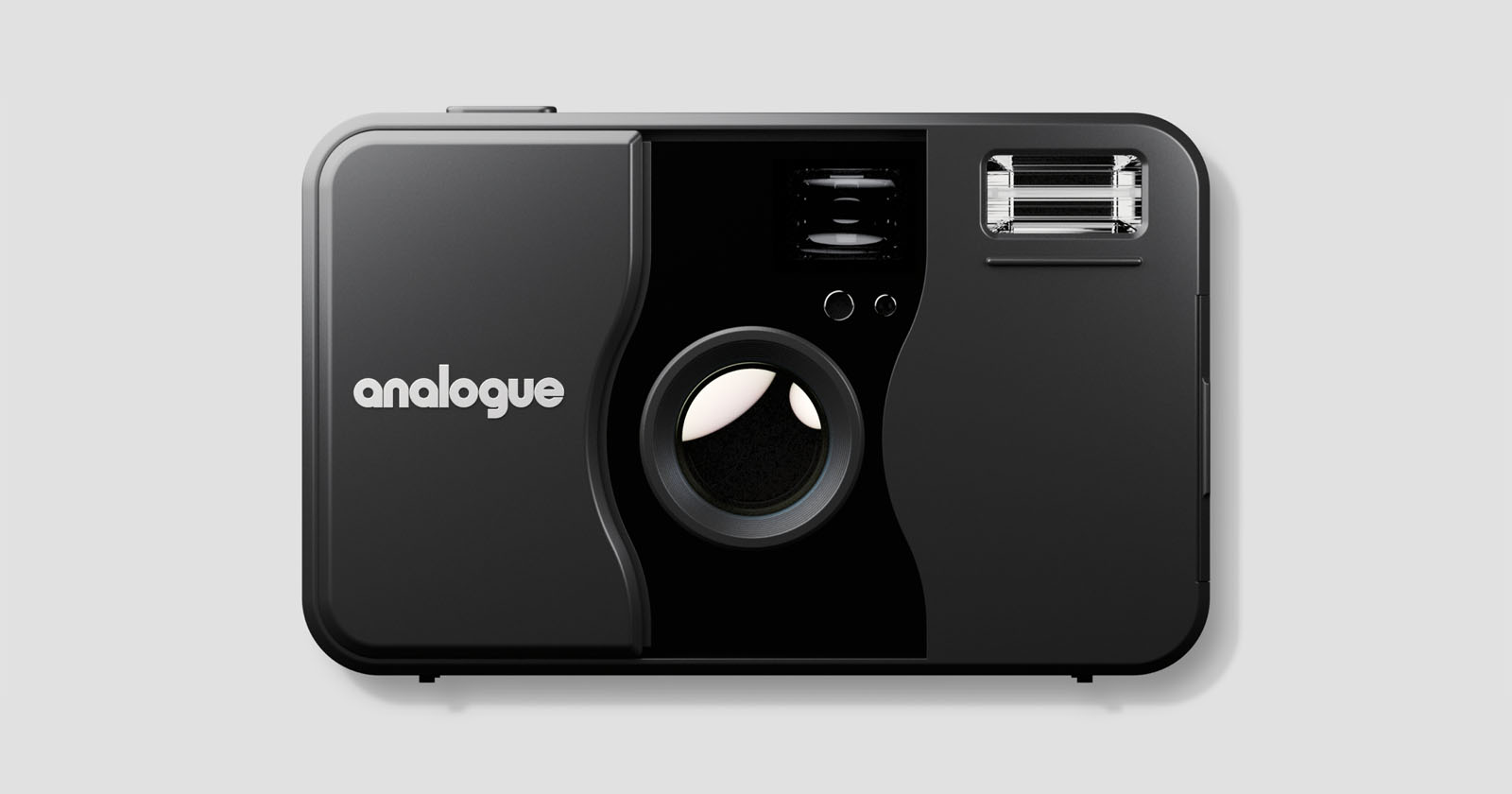 A black analogue film camera with a large lens in the center, a flash in the upper right corner, and the word "analogue" printed in white on the left side. The camera is shown against a plain gray background.