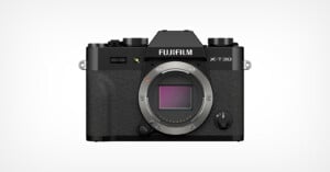 A Fujifilm X-T30 mirrorless camera body in black, shown from the front with the lens removed, revealing the camera sensor and textured grip. The brand and model name are visible above the sensor mount.