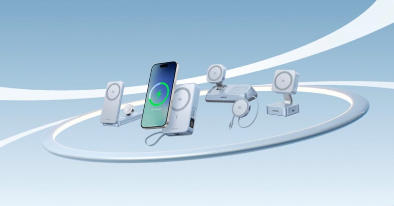 A smartphone and several white wireless charging devices are floating in a circular formation against a light blue gradient background with white curved lines.