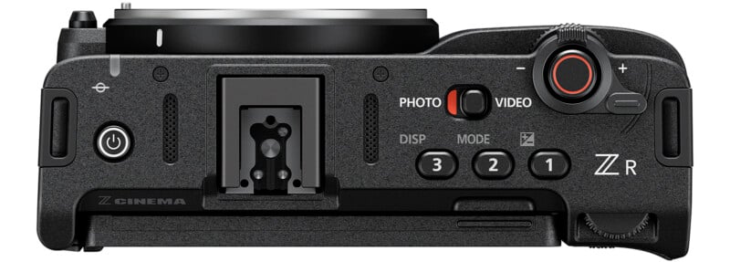 Top view of a black digital camera showing various buttons and dials labeled Photo, Video, DISP, MODE, and numbered buttons 1, 2, and 3, alongside a hot shoe mount and the ZCINEMA and Z R labels.