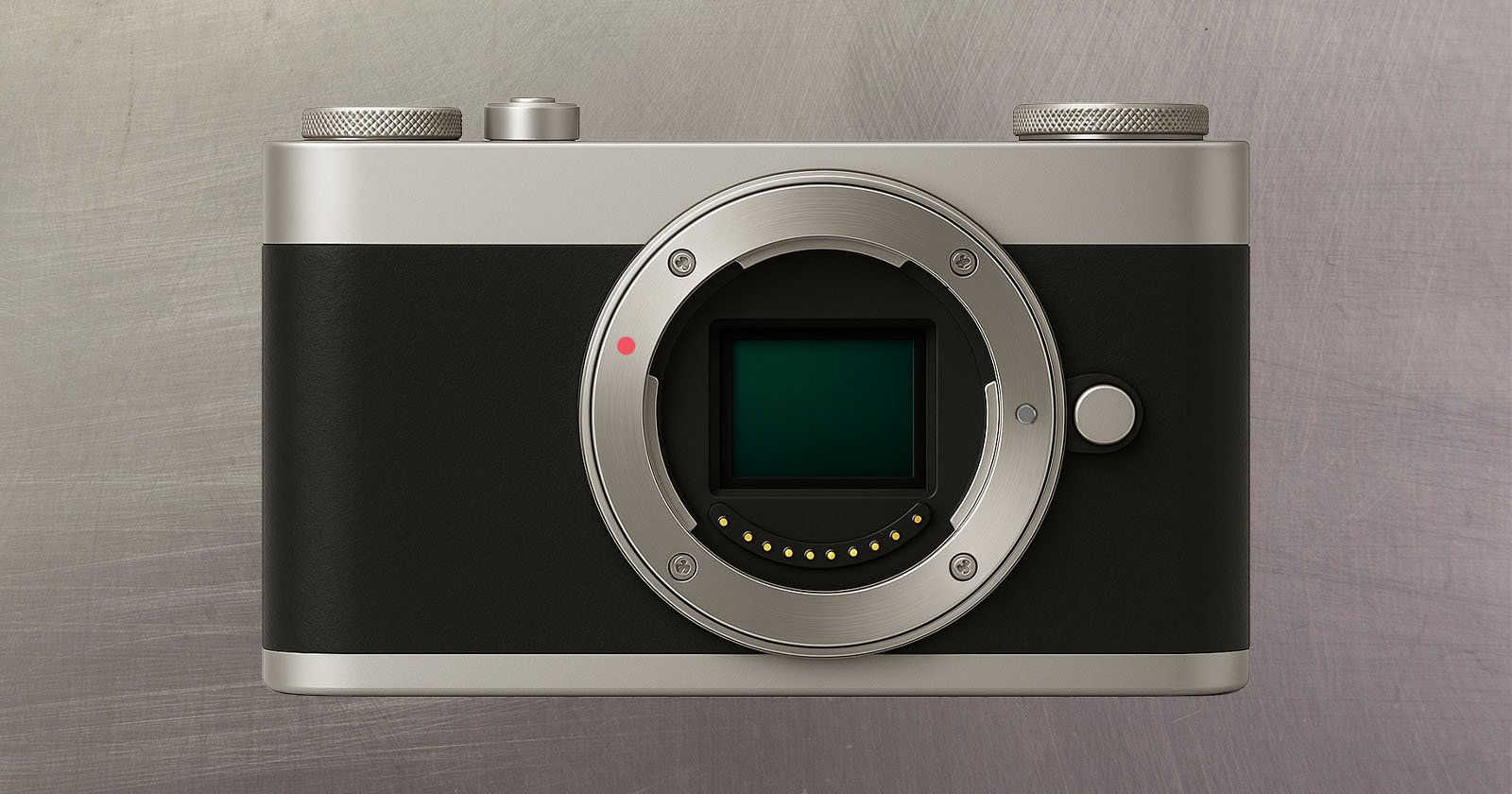 A digital camera body without a lens, featuring a silver and black design, is displayed against a brushed metal background. The camera’s sensor and lens mount are clearly visible.