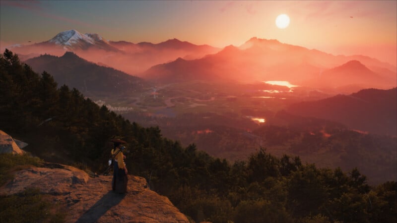 A person in traditional clothing stands on a rocky ledge overlooking a vast, forested valley at sunset with mountains, mist, and a glowing sun in the background.