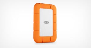 A portable LaCie external hard drive with a silver center and bright orange rugged rubber casing, shown standing upright on a white background.