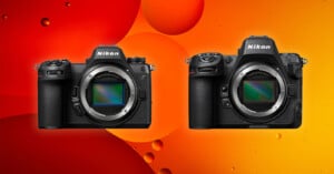 Two Nikon Z series mirrorless cameras side by side against a vibrant orange and red abstract background with circular shapes.